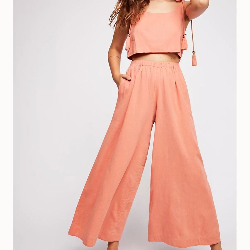 Free People jumpsuit, coral, adjustable straps, wide leg, front cutout. Size M